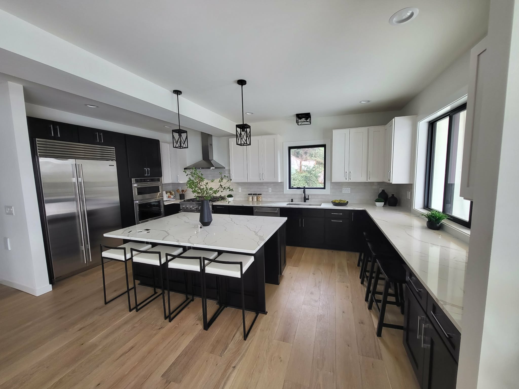 Custom kitchen remodel with dark cabinetry and waterfall island
