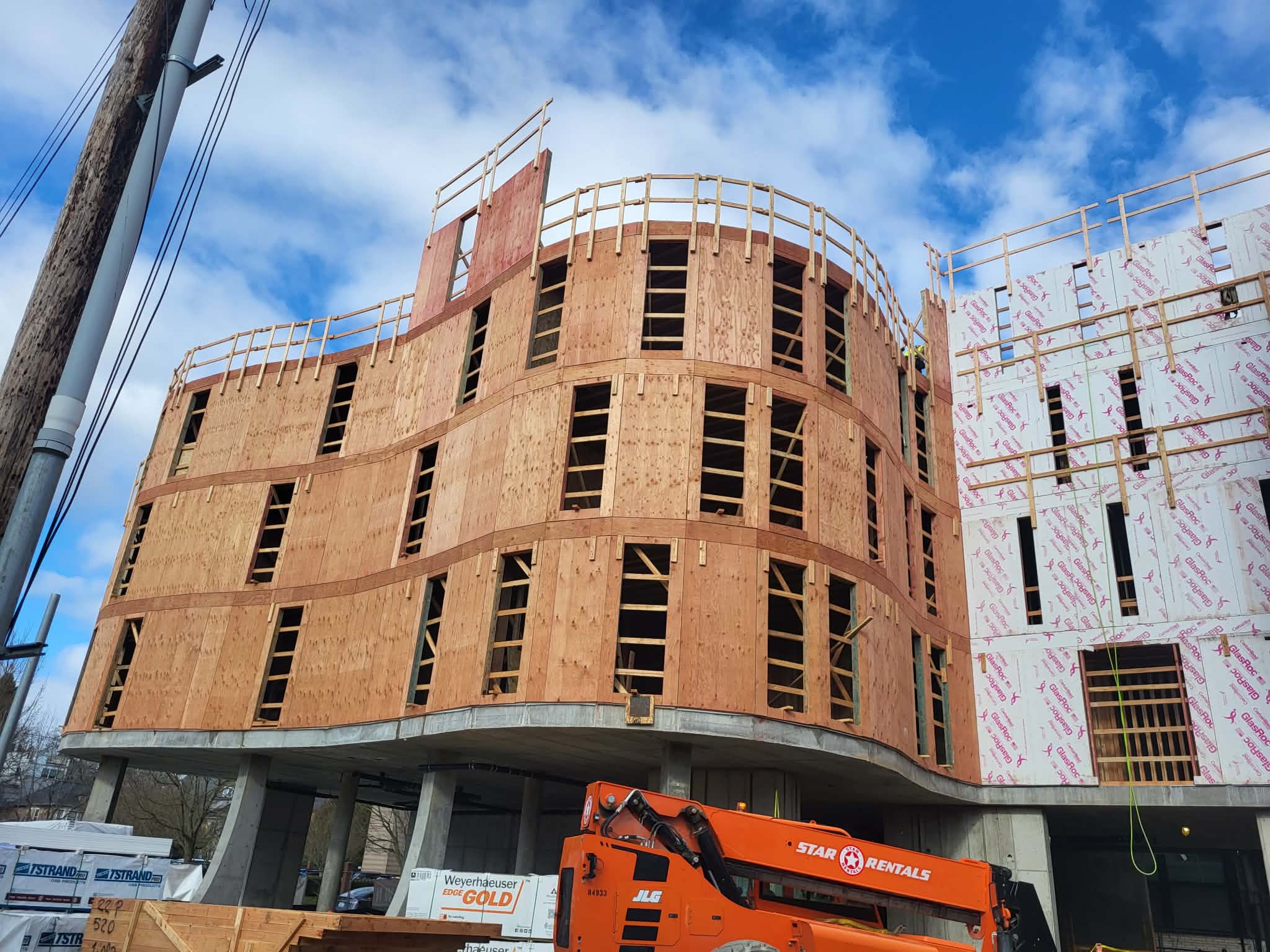 Large curved commercial framing structure with lift equipment
